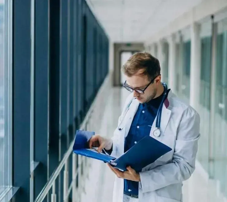 Doctor reviewing patient reports in a Hospital POS System, highlighting the daily challenges faced by hospital management teams.